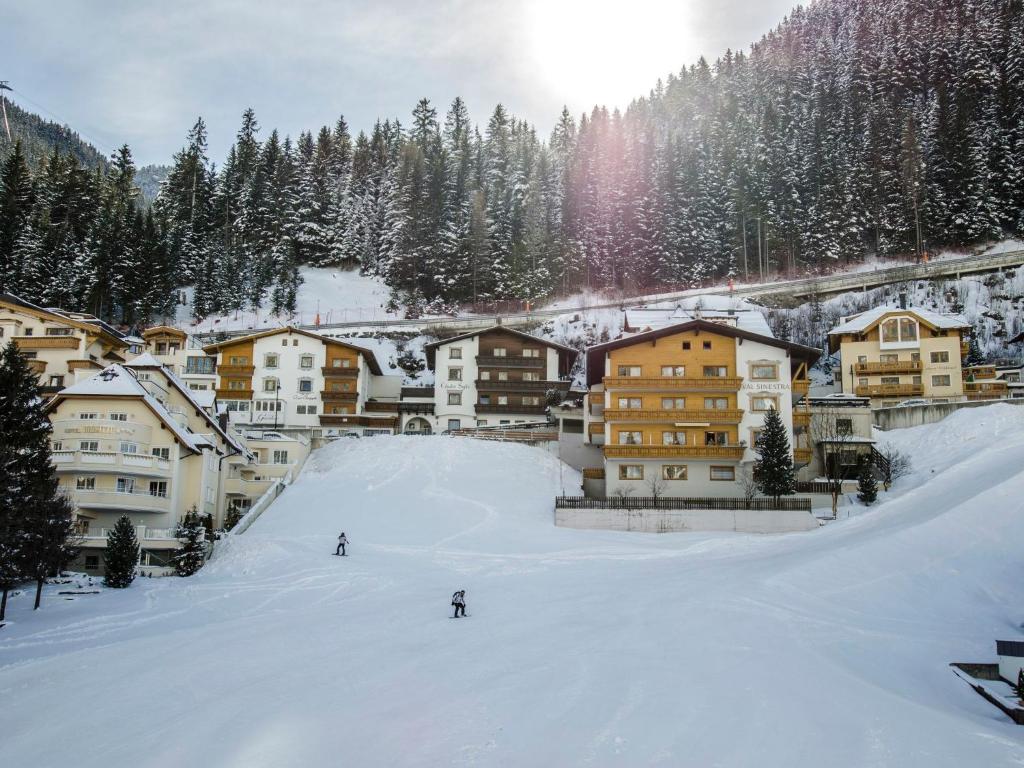 a group of people skiing down a snow covered slope at Apartment Top 7 by Interhome in Ischgl