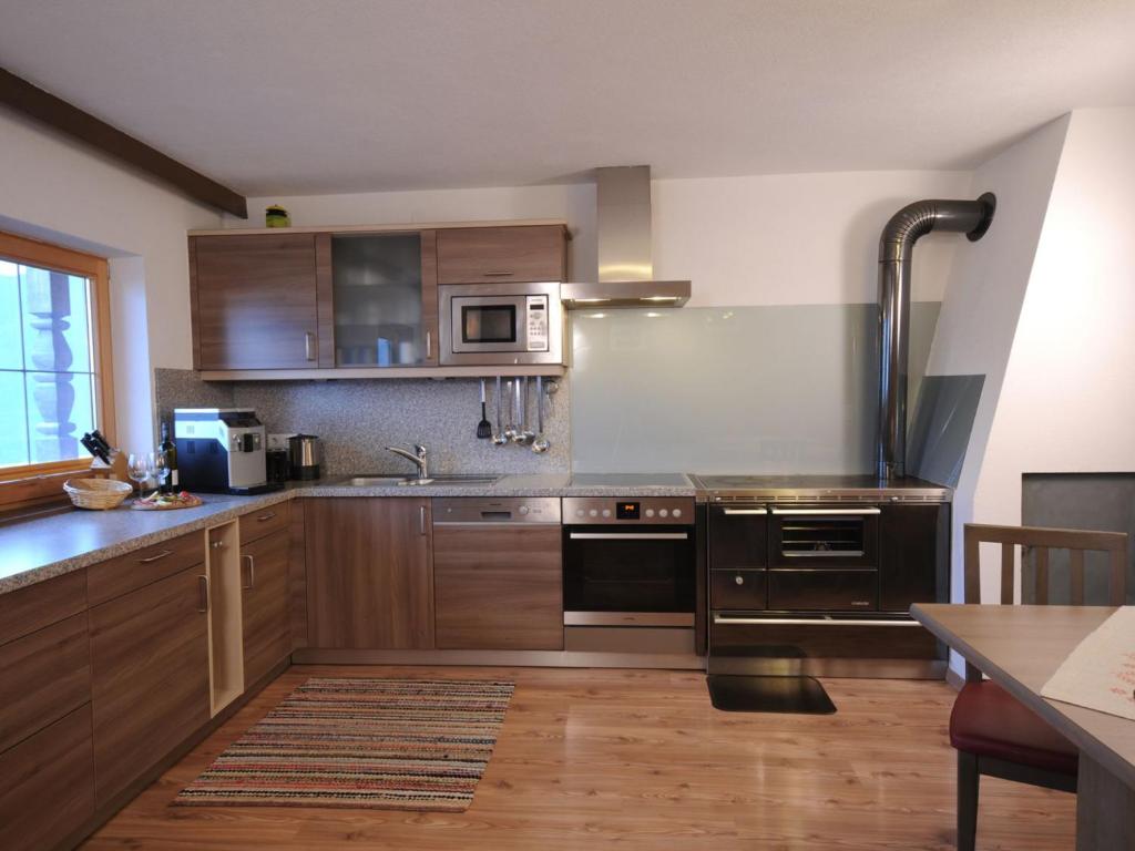 a kitchen with wooden cabinets and stainless steel appliances at Holiday Home Pfundshof by Interhome in Hippach