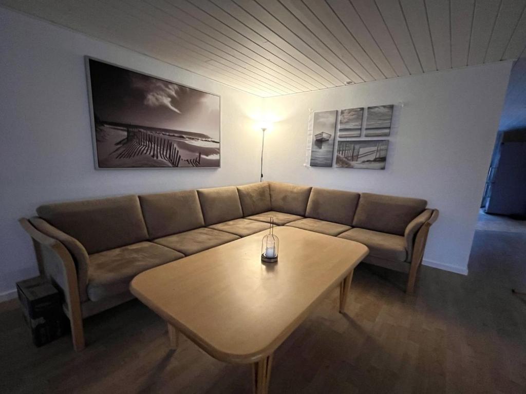 a living room with a couch and a coffee table at Holiday Home Geske - all inclusive - 3-2km from the sea in Sealand by Interhome in Eskebjerg
