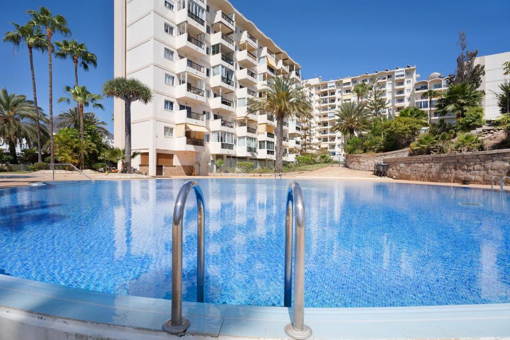 a large swimming pool in front of a building at Apto El Dorado 929 in Playa de las Americas
