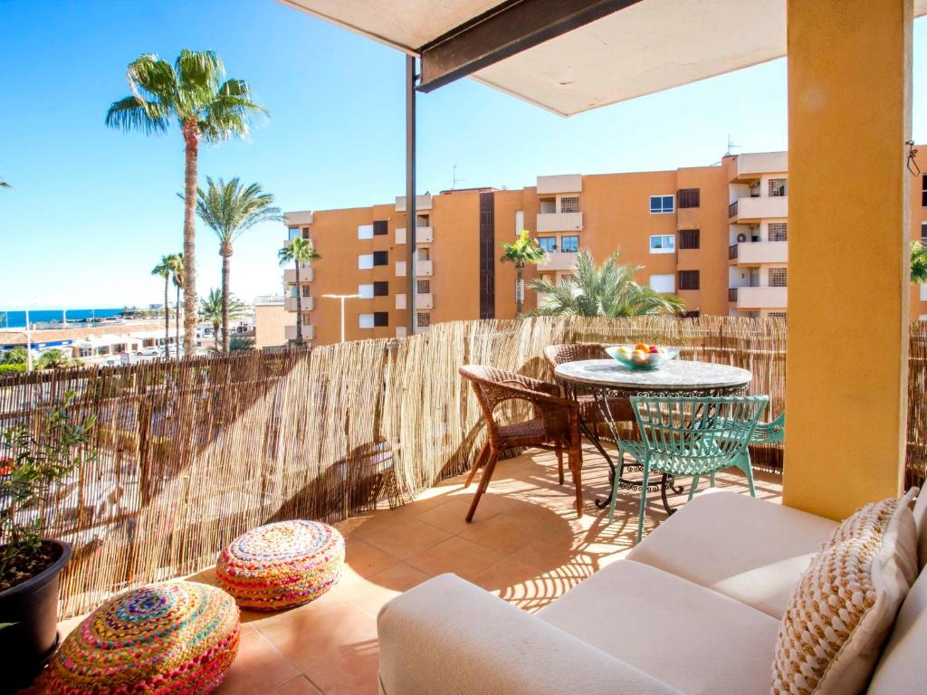a patio with a table and chairs on a balcony at Apartment Vista del Arenal by Interhome in Jávea