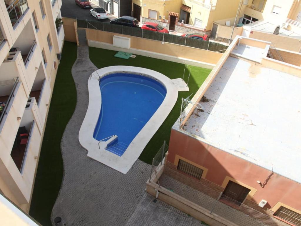 an overhead view of a swimming pool on a building at Apartment Dioniso - Playa Romanilla by Interhome in Roquetas de Mar