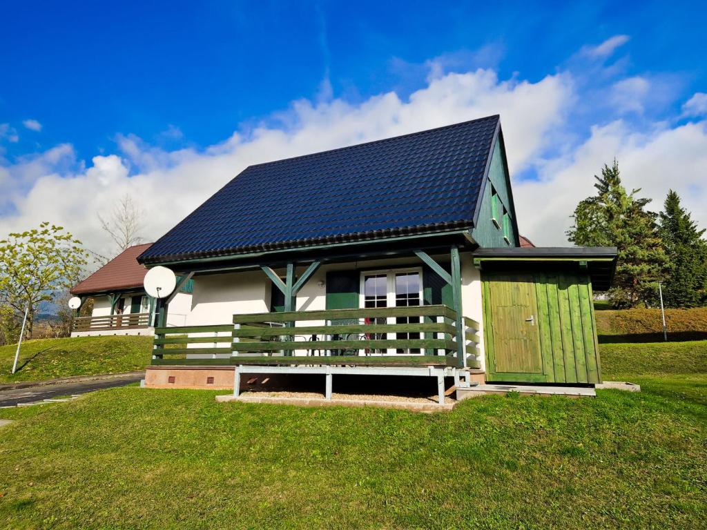 una piccola casa con un tetto solare sull'erba di Holiday Home Holiday Hill 37 by Interhome a Černý Dŭl