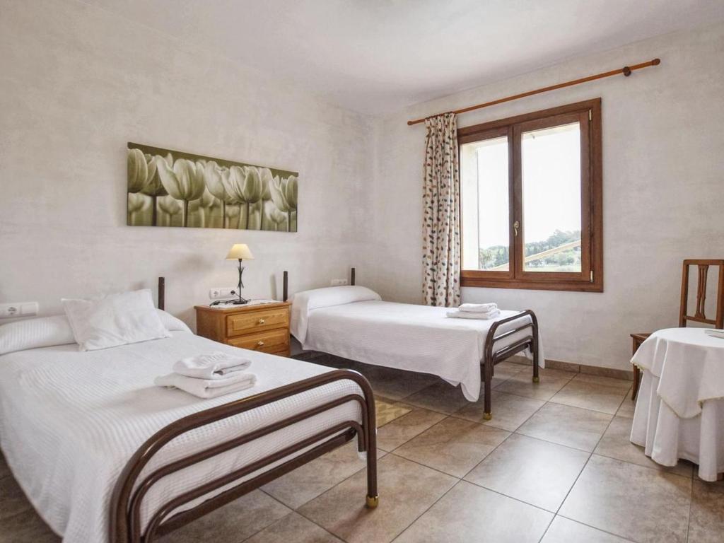 A bed or beds in a room at Holiday Home Pla De Ses Rotes by Interhome