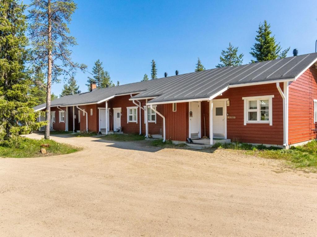 a red barn with a dirt road in front of it at Holiday Home Urupää c 13 by Interhome in Saariselka