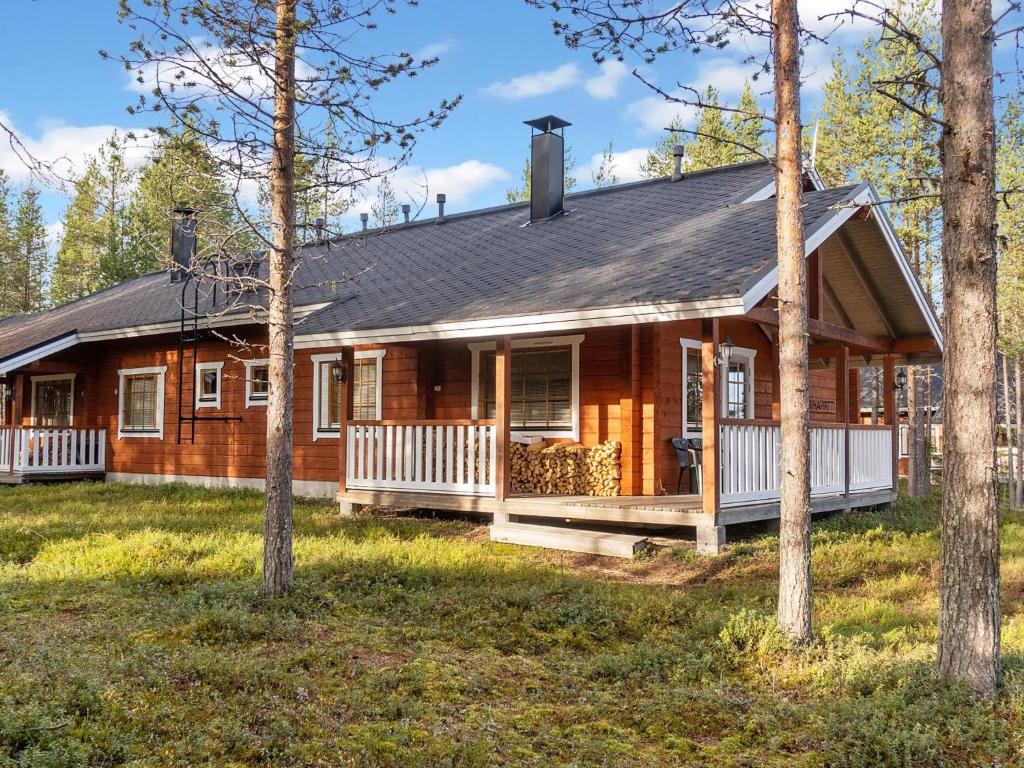 a log cabin with a porch and a porch at Holiday Home Puuhapirtti 1 by Interhome in Sirkka
