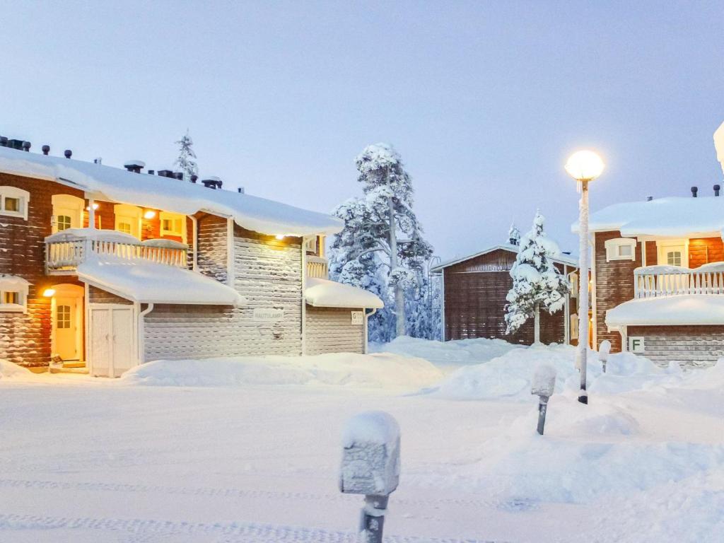 a snow covered yard with two parking meters at Holiday Home Outapailakka j 10 by Interhome in Saariselka