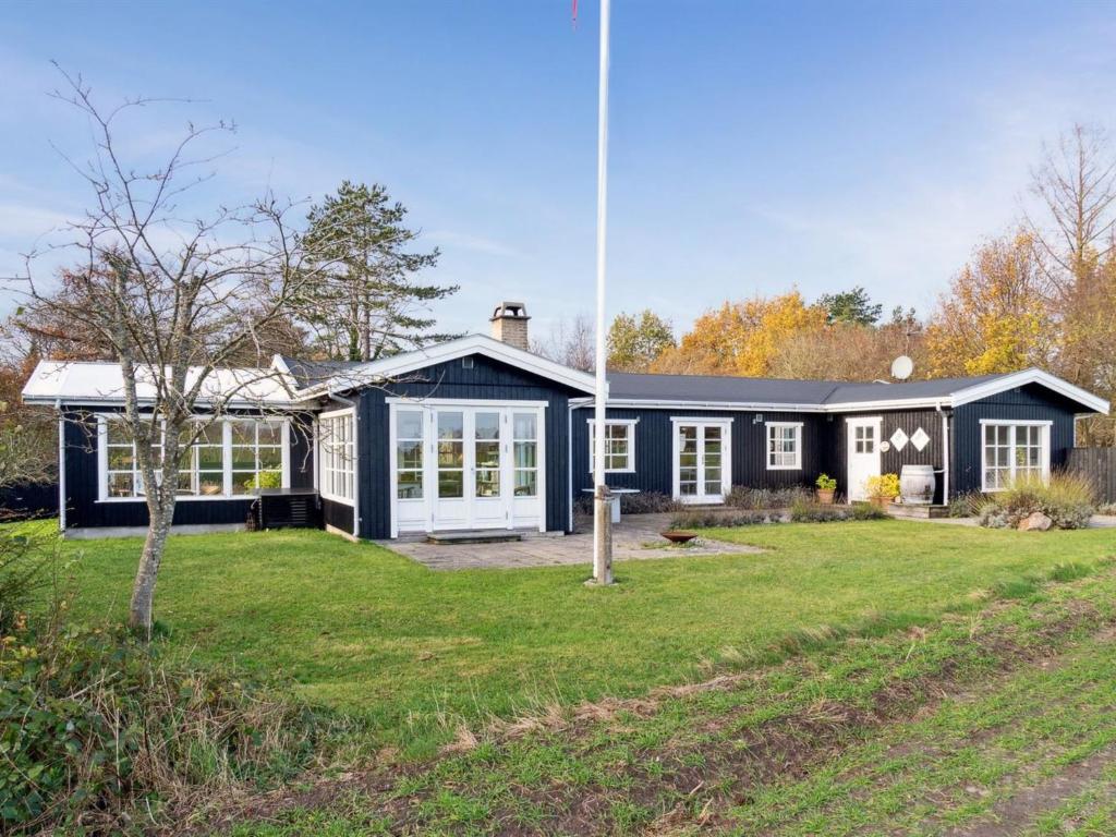 a home with a blue and white house at Holiday Home Mimi - all inclusive - 800m to the inlet by Interhome in Rørvig