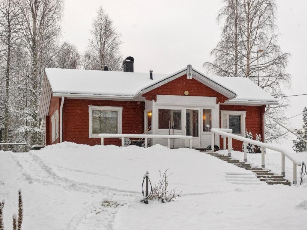 a house covered in snow in the yard at Holiday Home Käpälämäki by Interhome in Raanujärvi