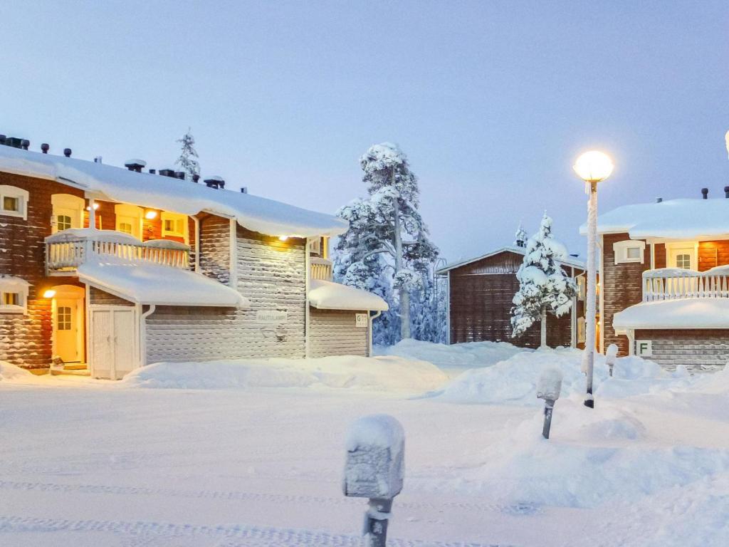 a snow covered yard with two parking meters at Holiday Home Outapailakka j 9 by Interhome in Saariselka