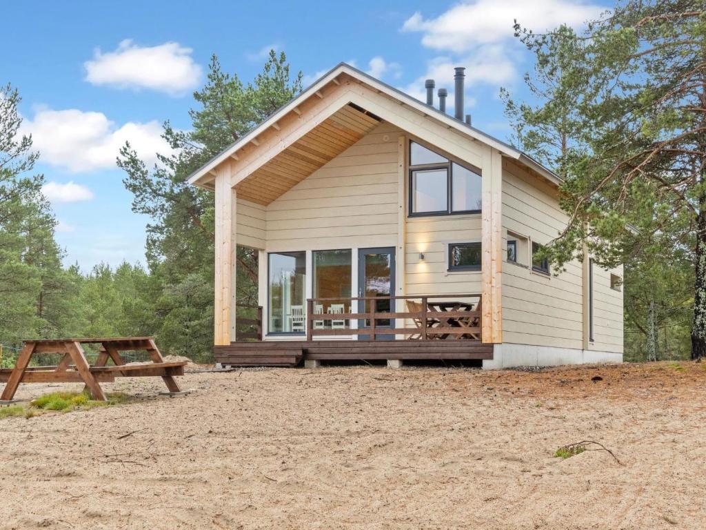a tiny house with a large window and a picnic table at Holiday Home Siika by Interhome in Hailuoto