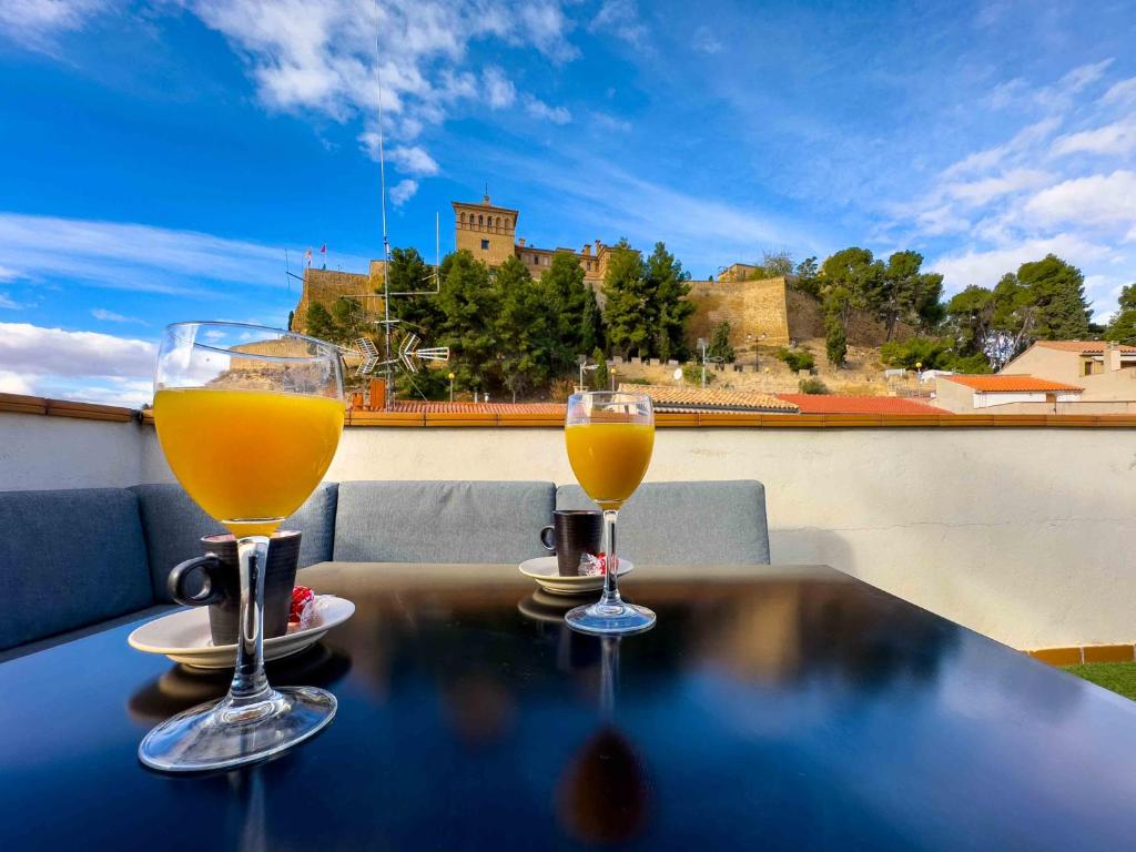 two glasses of orange juice sitting on a table at MEQUEDO CALDEREROS 25 in Alcañiz