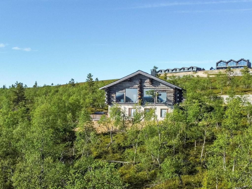 a house on top of a hill with trees at Holiday Home Uuvana by Interhome in Saariselka