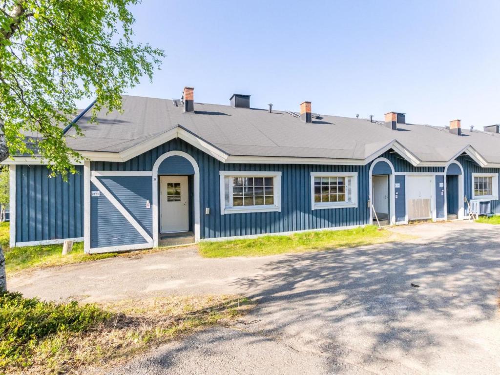 a blue house with a gray roof at Holiday Home Teerenpesue e 38 by Interhome in Saariselka