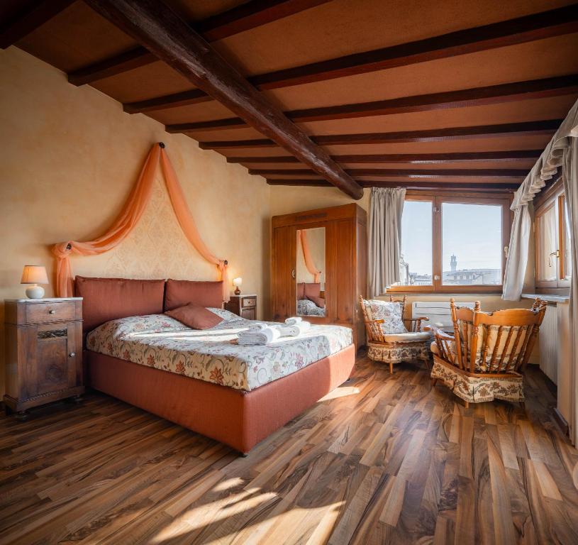 a bedroom with a bed and a table and chairs at Novella House in Florence