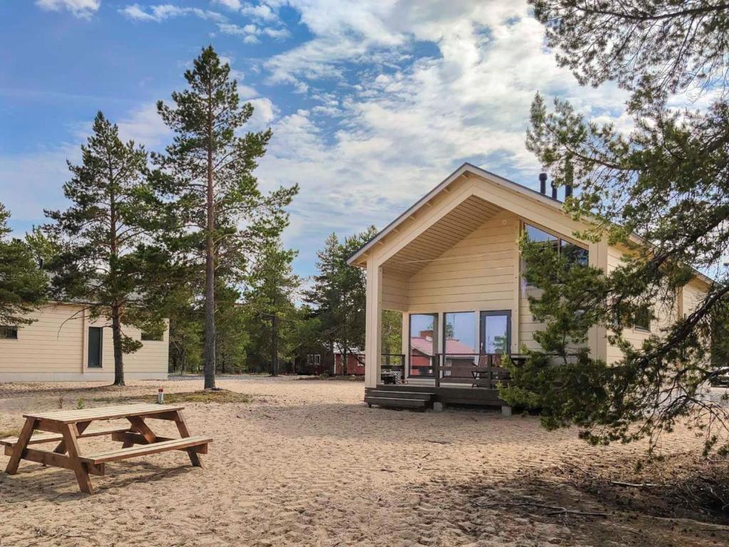a house with a picnic table and a bench at Holiday Home Taimen by Interhome in Hailuoto