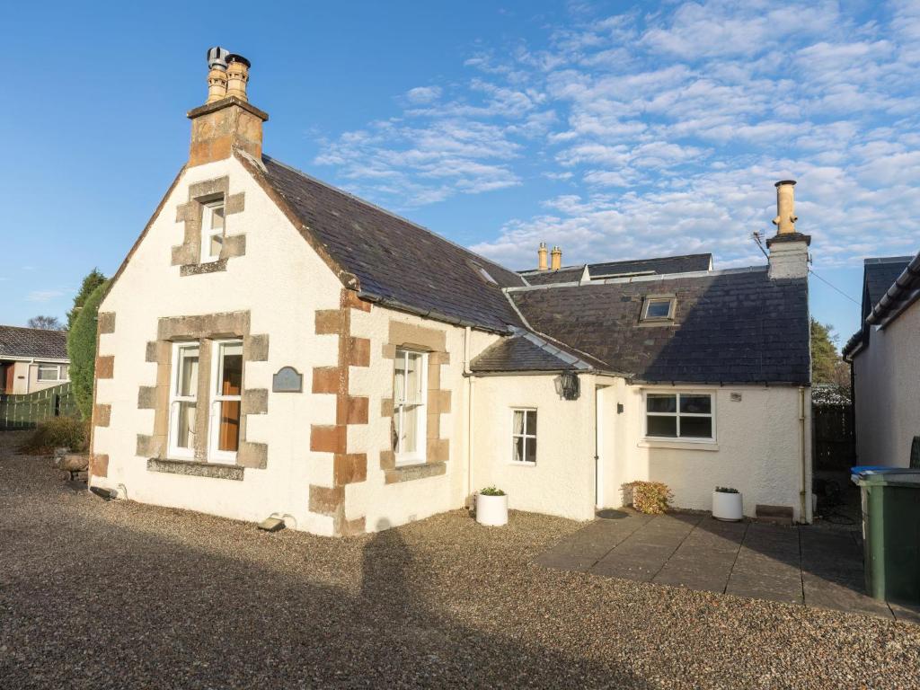 a white house with a black roof at Holiday Home Lodge Road-2 by Interhome in Inverness