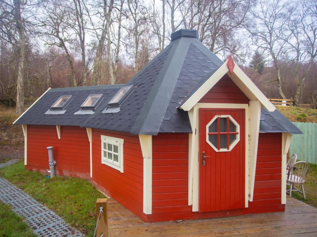 a red house with a grey roof and a red door at Chalet Campbell by Interhome in Drumnadrochit