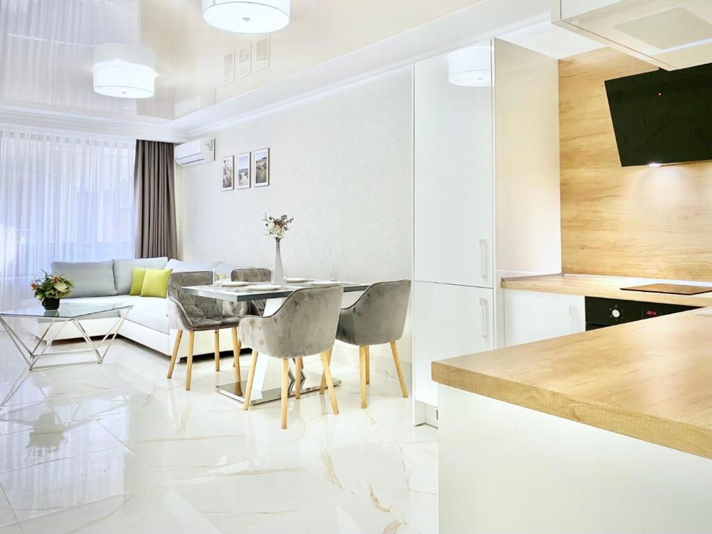 een keuken en een woonkamer met een tafel en stoelen bij Sea View Apartment with Free Parking in Pomorie