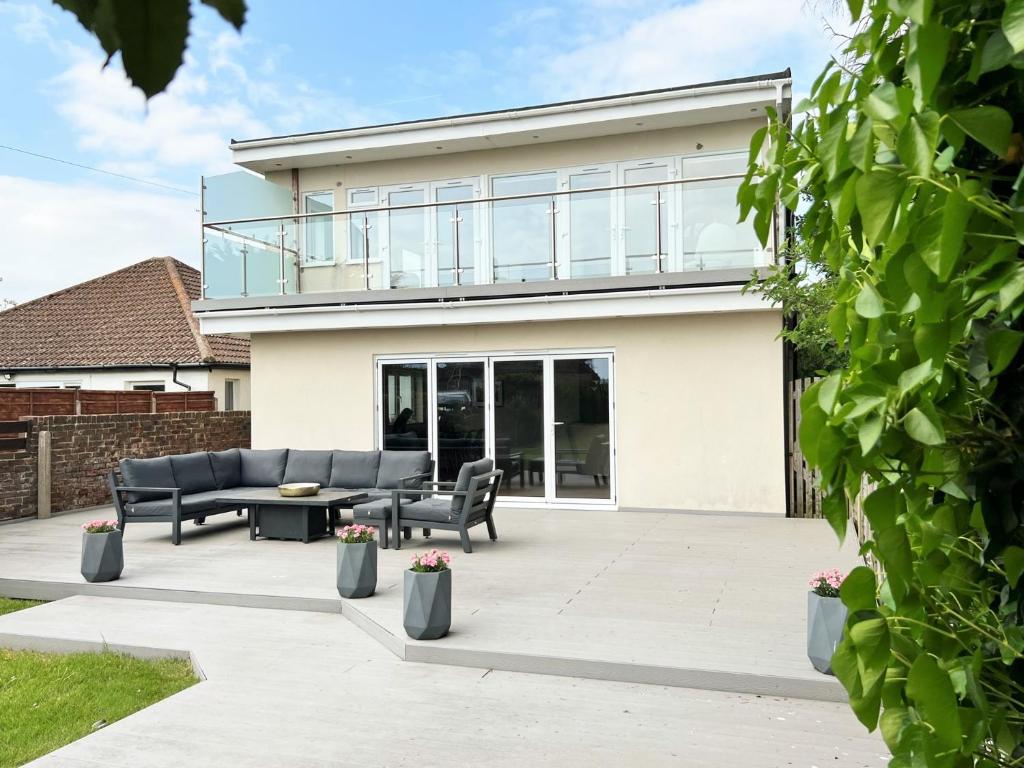 a house with glass walls and a patio at 4 bed in Worthing 83354 in Ferring