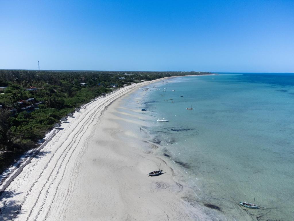 an aerial view of a beach with boats in the water at Samara Lodge in Vilanculos