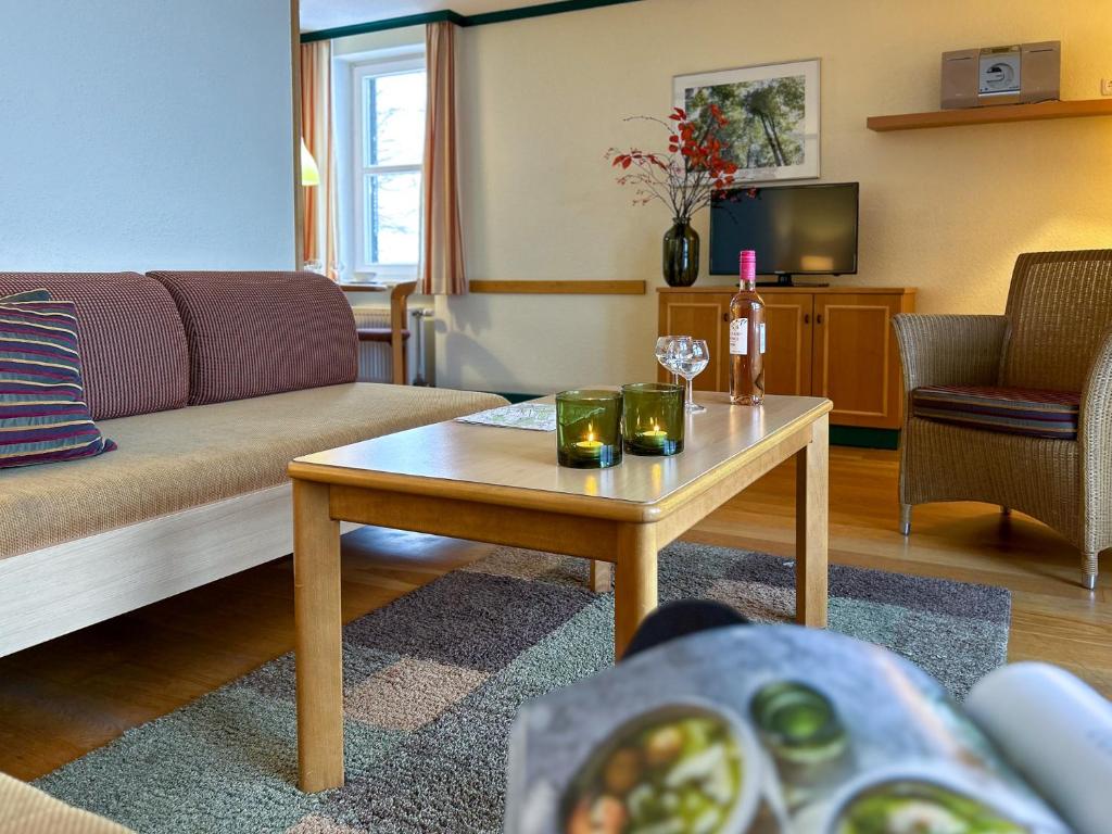 a living room with a couch and a coffee table at UplandParcs Bergresidence in Winterberg