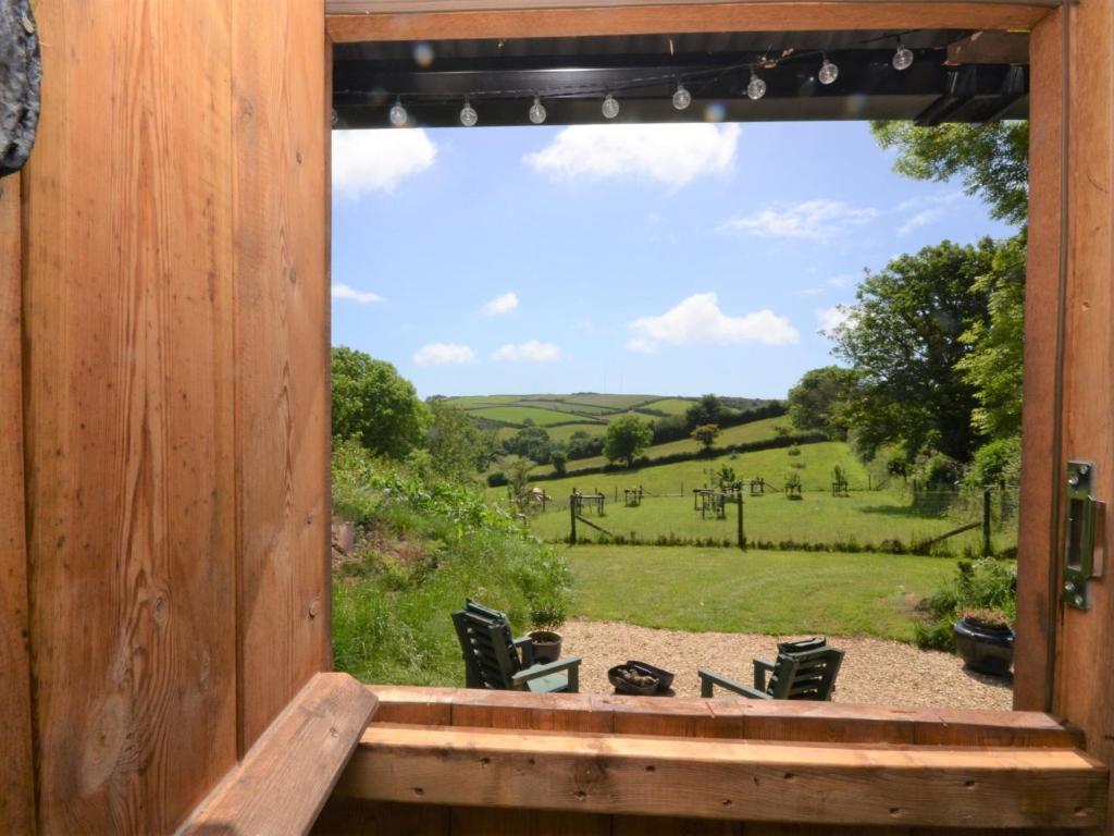 a window view of a field from a cabin at 1 bed property in Beesands 86462 in Beesands