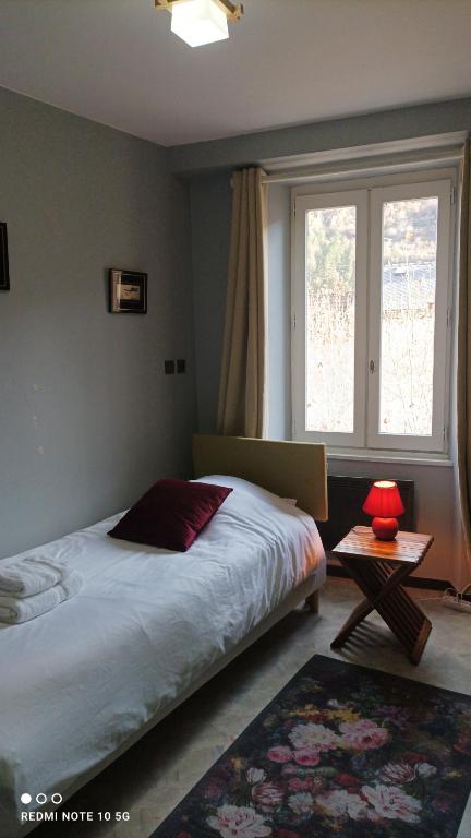 Postel nebo postele na pokoji v ubytování DÉDÉ DU VAL B&B