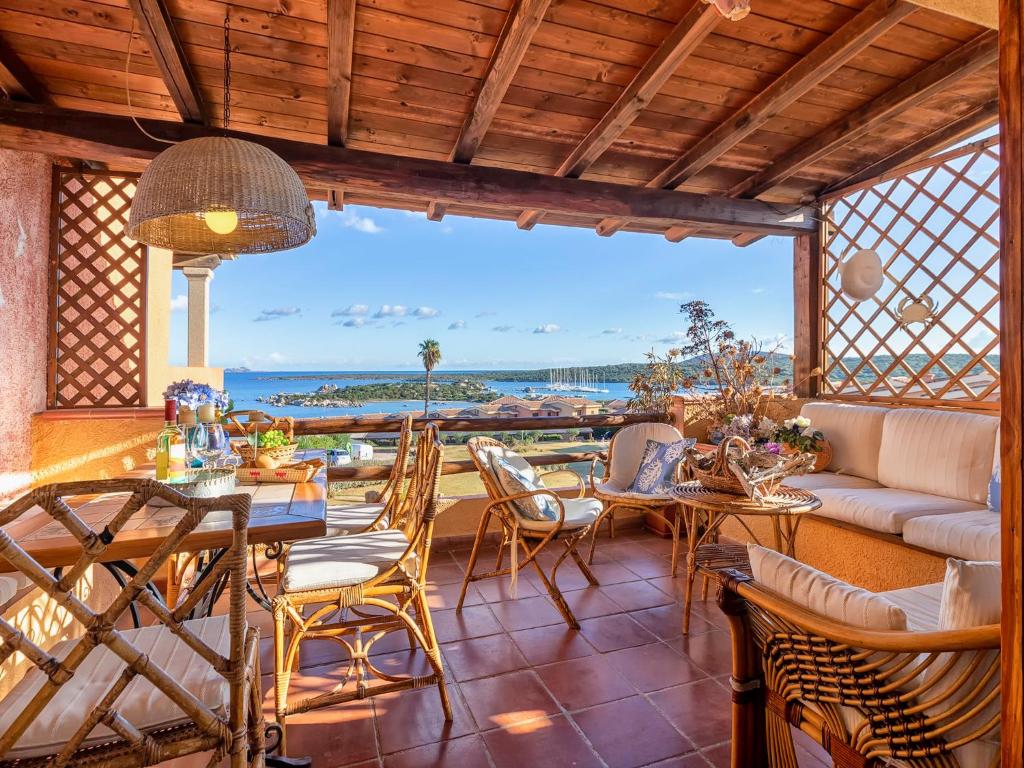 a patio with a table and chairs and a view of the ocean at Apartment E-1-4 - Marineledda by Interhome in Golfo Aranci