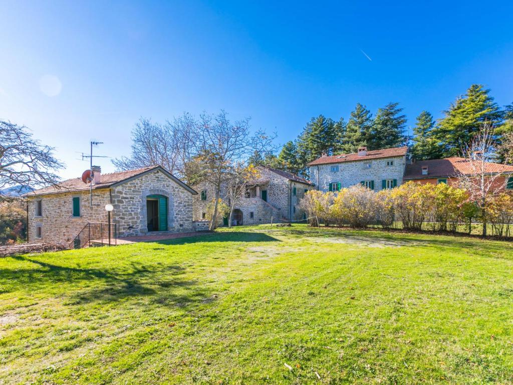 an old stone house on a grassy field at Holiday Home Al Volo del Nibbio by Interhome in Marradi