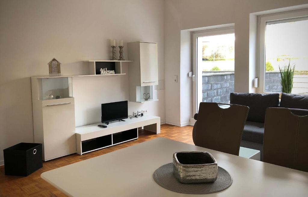 a living room with a couch and a television at Schneiders Ferienwohnung 4 in Braunshausen