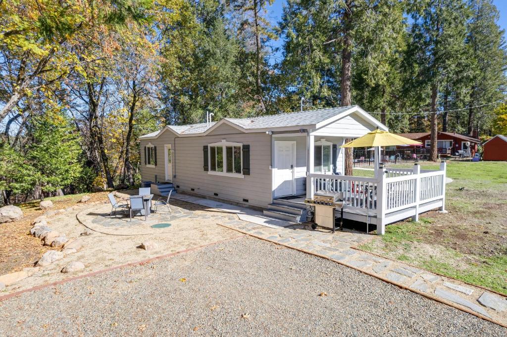 a tiny house with a porch and a deck at Cozy Placerville Cottage with Pool on Livestock Farm in Placerville