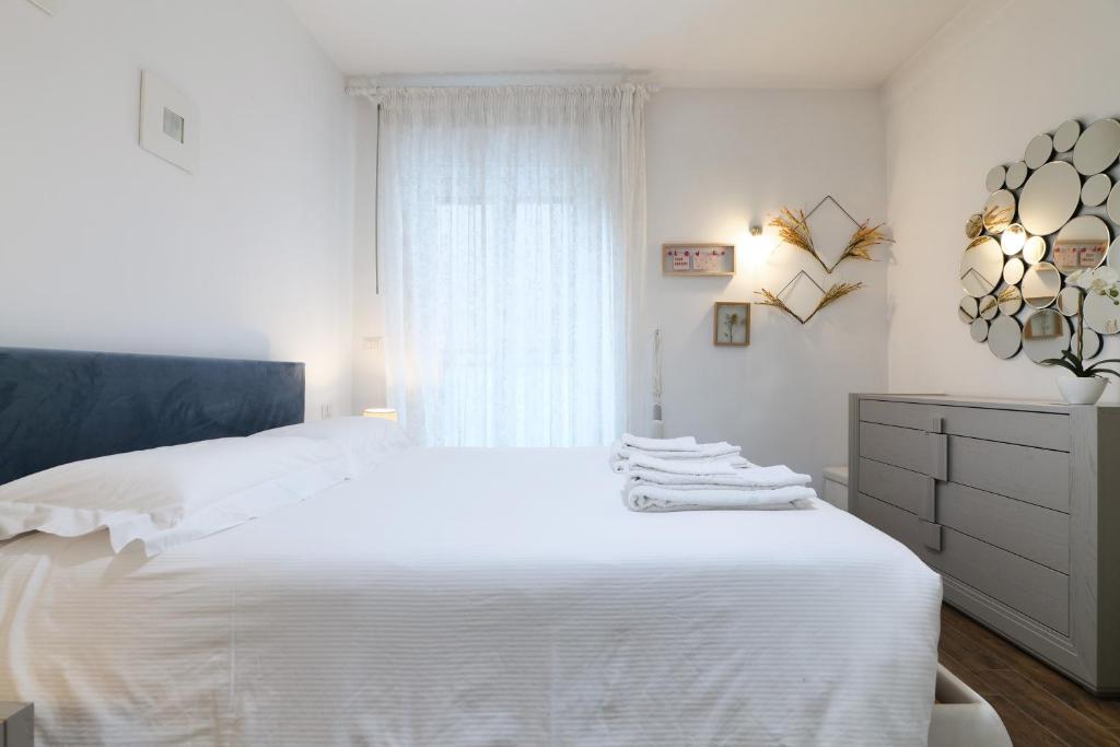 - une chambre avec un lit blanc et une fenêtre dans l'établissement Mila Apartments Battista, à Milan
