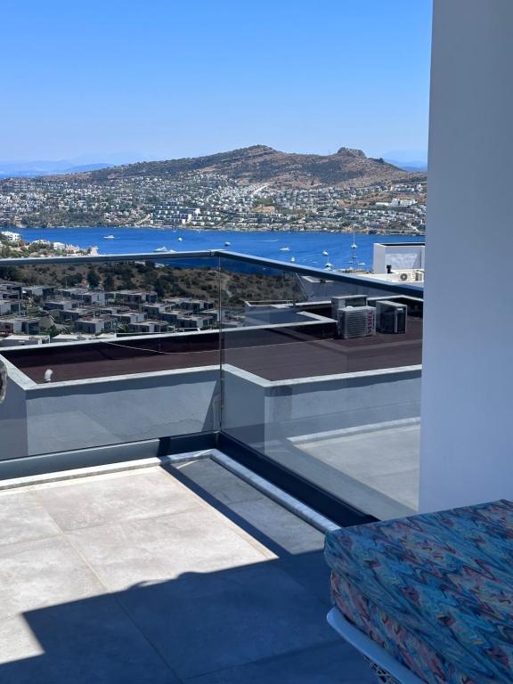 a balcony with a view of a city and the ocean at Q2 Çiçek sitesi in Bodrum City