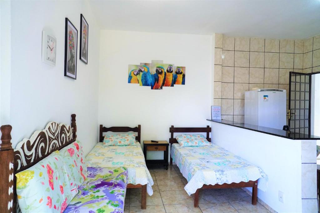 Zimmer mit 2 Betten und einem Kühlschrank in der Unterkunft Casa Central em Pará de Minas in Pará de Minas