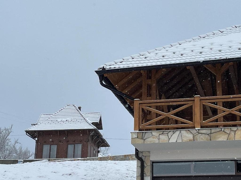 a snow covered roof of a house and a building at Seoski turizam Žigale 