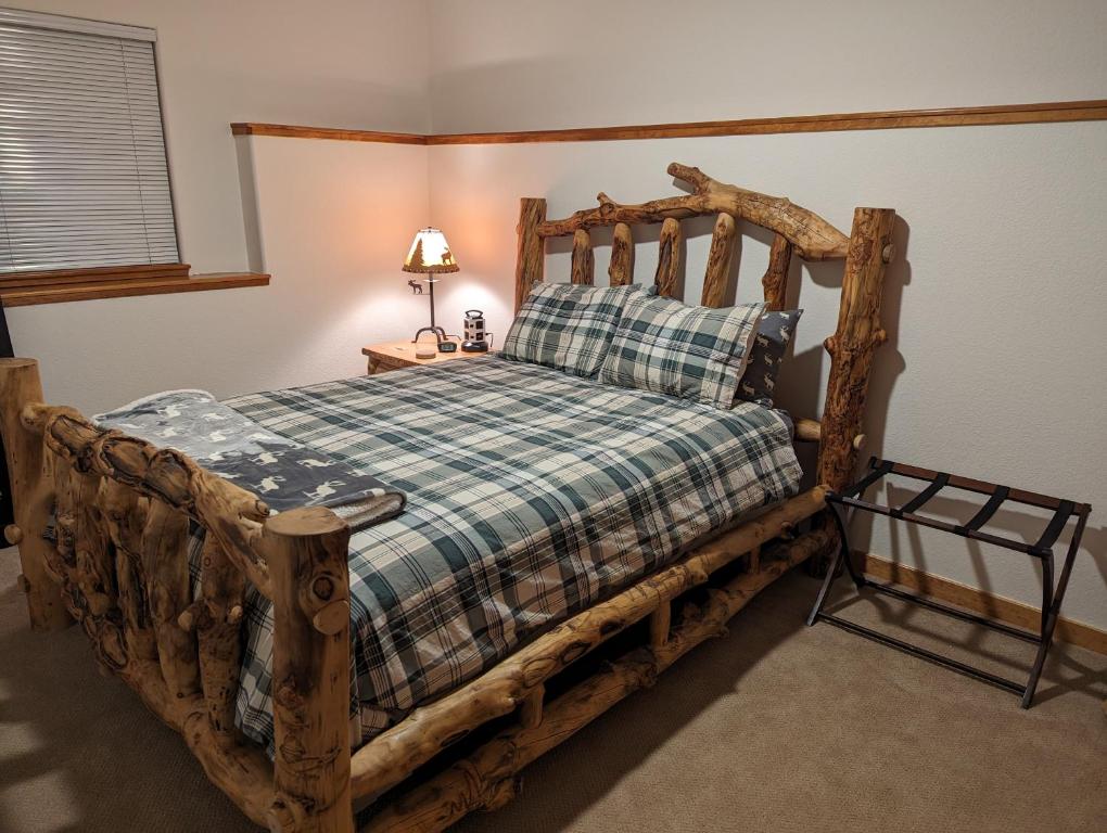 a bedroom with a wooden bed with a wooden frame at Park-like setting in-law apartment less than a mile to Evergreen in Evergreen