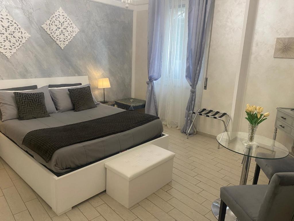 a bedroom with a king sized bed and a table at Few Steps from Vatican City in Rome