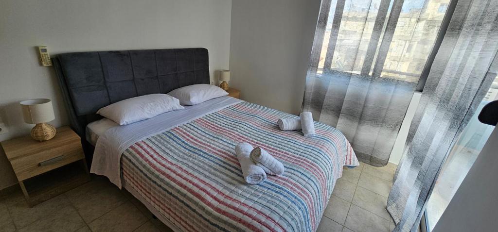 Postel nebo postele na pokoji v ubytování Primordial Apartment