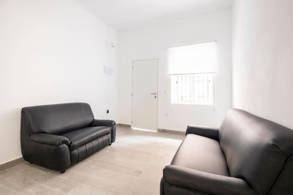 ein Wohnzimmer mit einer Couch und einem Sessel in der Unterkunft Acogedor alojamiento a pocos metros de la playa in Santa Pola