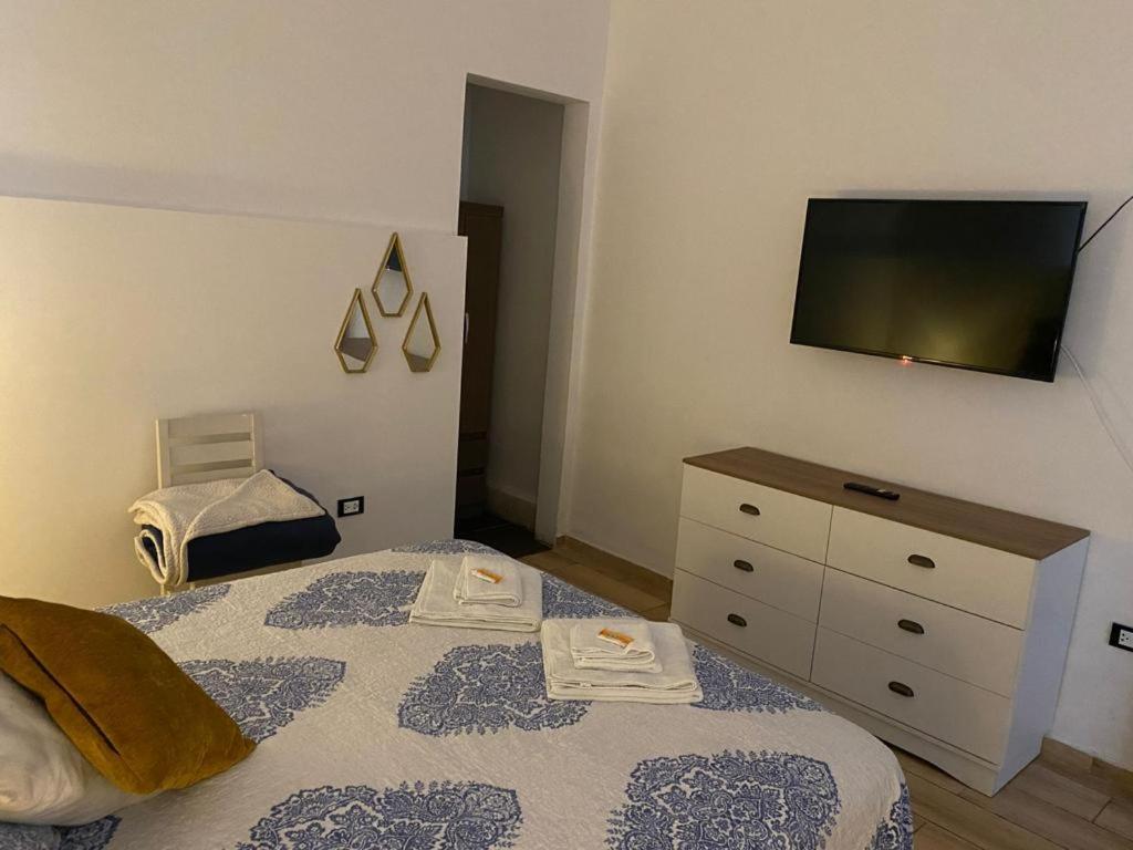 a bedroom with a bed with a television on the wall at Luxury Apartments Lima in Lima