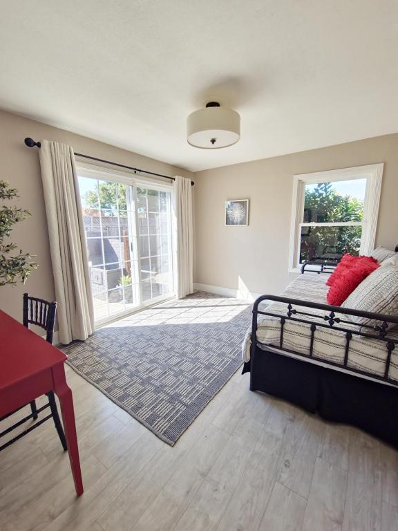 a bedroom with a bed and a large window at Bungalow Oasis in Concord