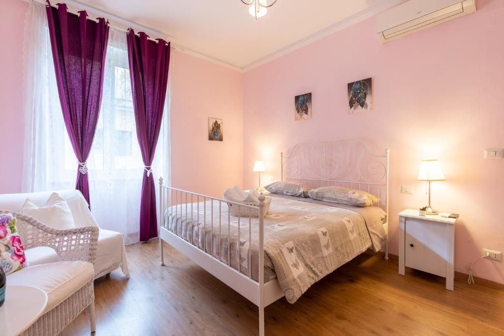 ローマにあるラ カサ イン フィオーレのベッドルーム(白いベッド1台、紫色のカーテン付)