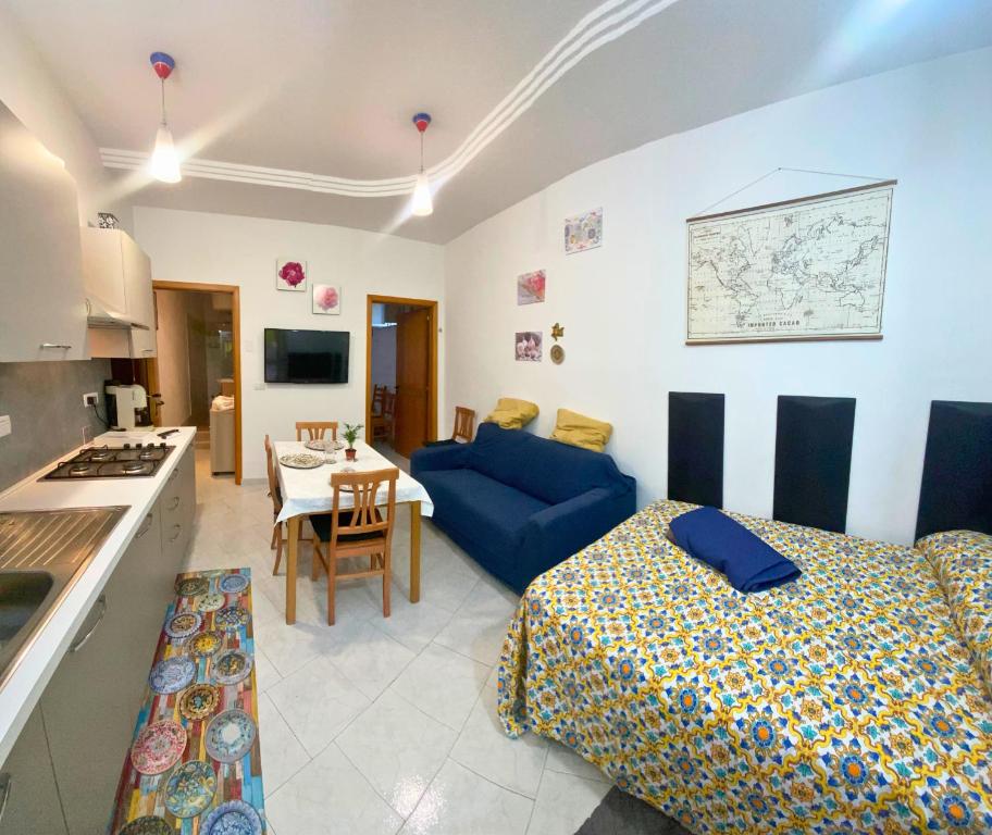 eine Küche und ein Wohnzimmer mit einem Bett und einem Sofa in der Unterkunft Acireale Centro in Acireale