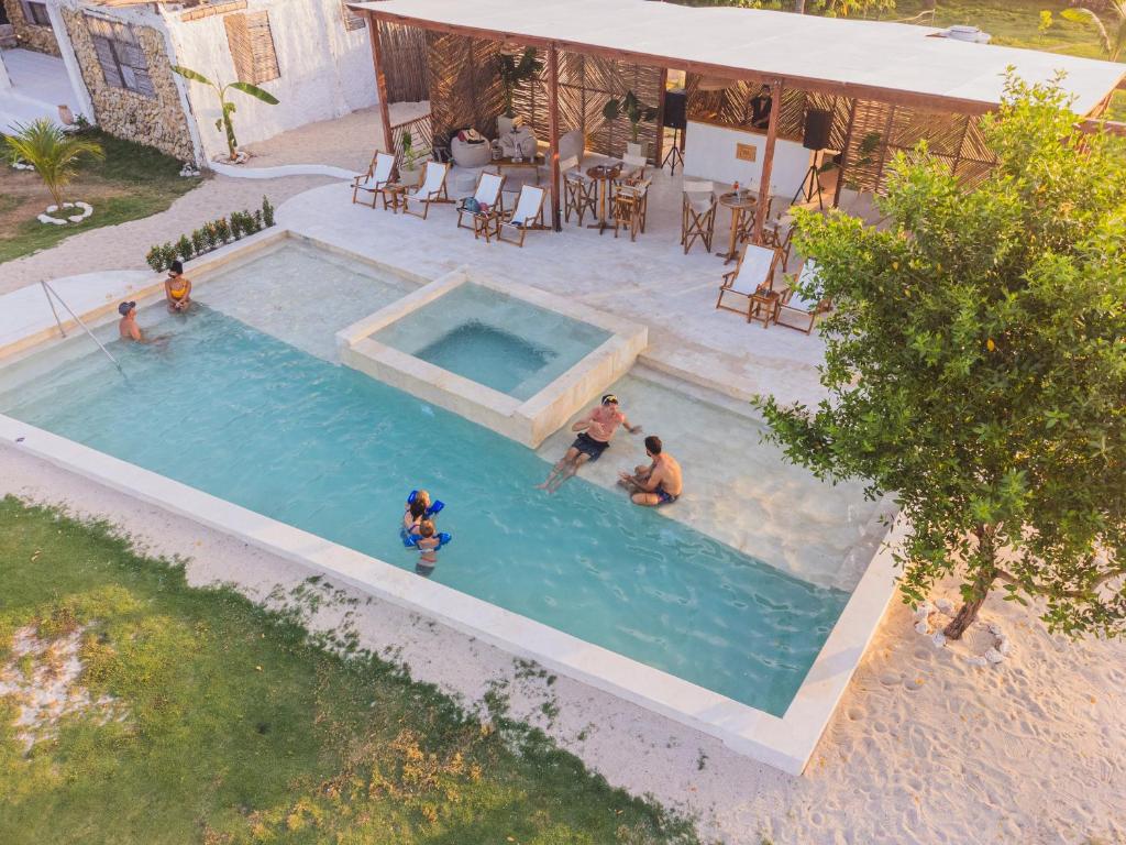 Vista Mare Beach House في تييرا بومبا: إطلالة علوية على أشخاص يلعبون في مسبح
