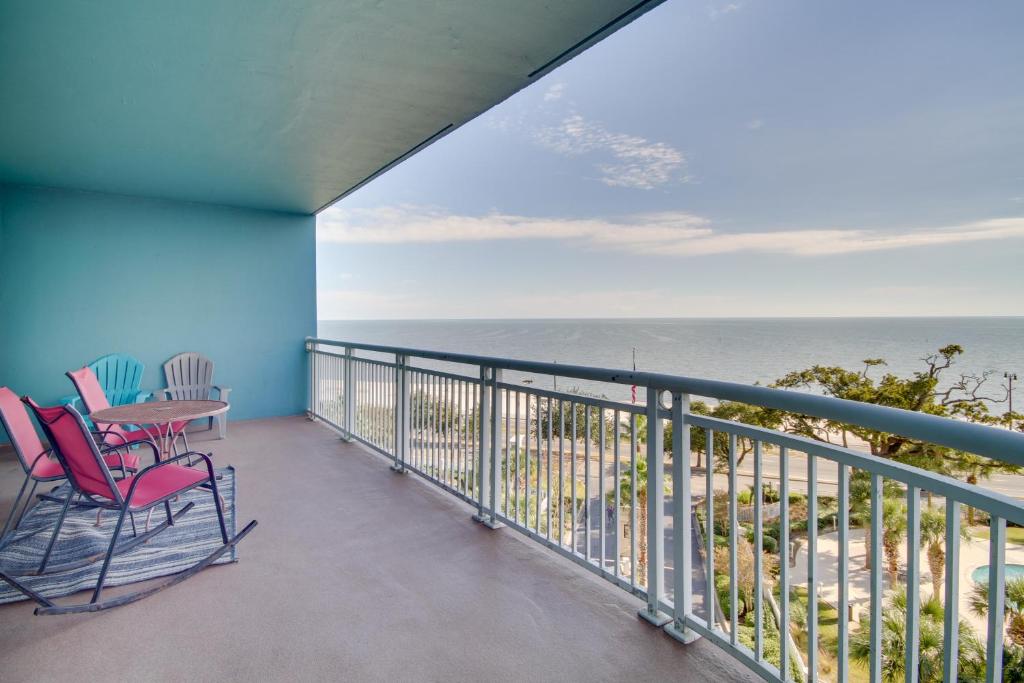 a balcony with chairs and a table and the ocean at 6th-Floor Gulfport Condo with Views Walk to Beach in Gulfport