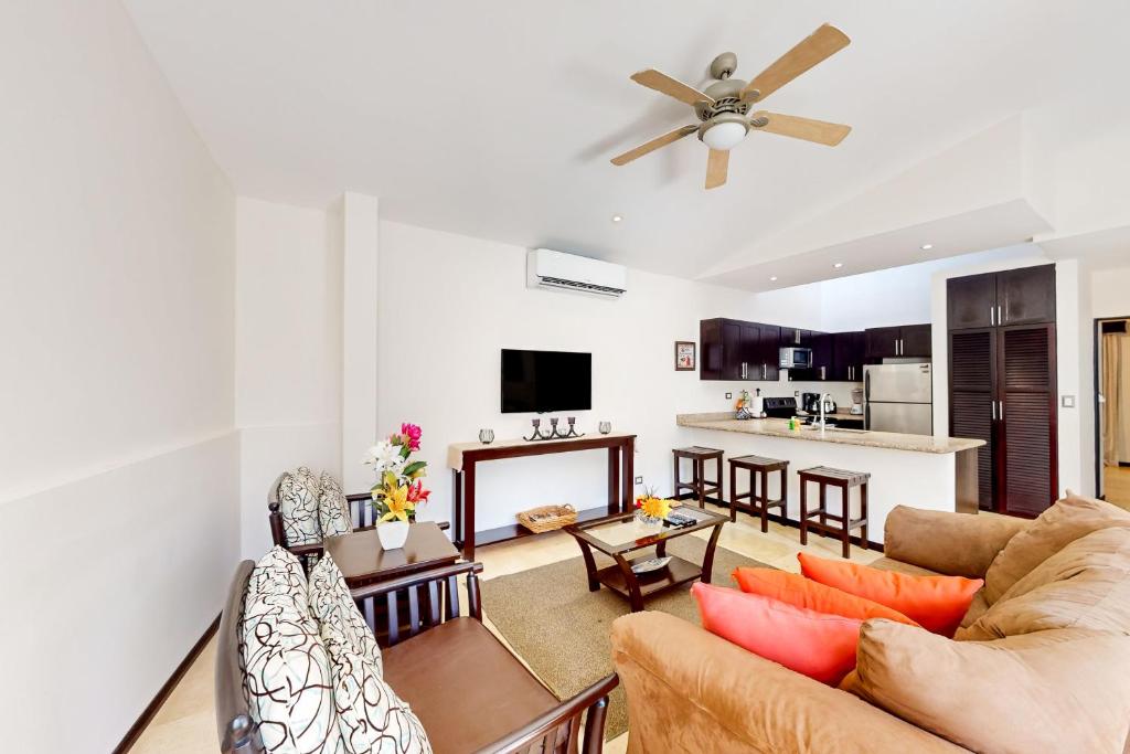 a living room with a couch and a ceiling fan at The Cove #16 in Ocotal