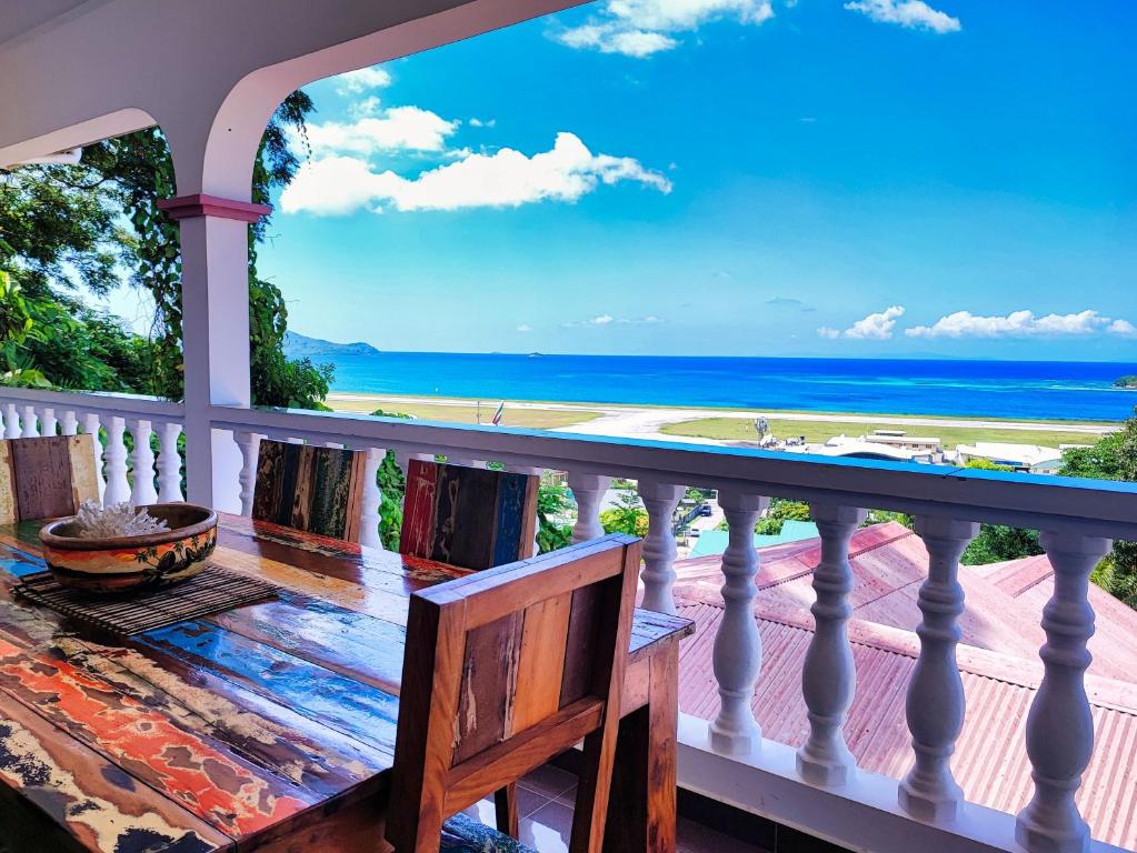a balcony with a view of the ocean at Villea Frangipani in Mahe