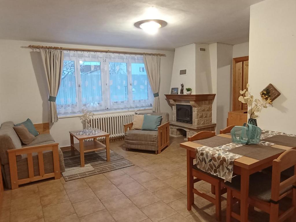 ein Wohnzimmer mit einem Sofa und einem Tisch in der Unterkunft Apartments Ľubka in Zuberec