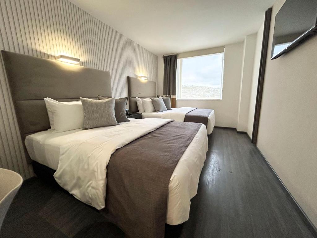 Postel nebo postele na pokoji v ubytování HUNICO HOTEL